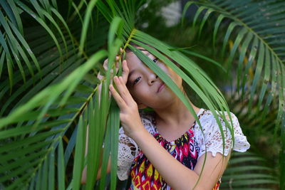 Portrait of girl by plants