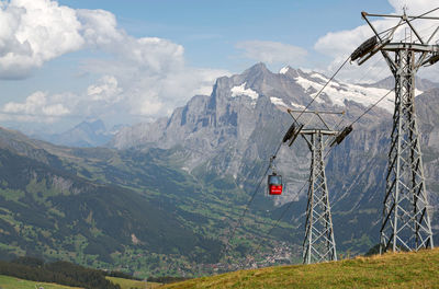 Overhead cable car and mountains against sky