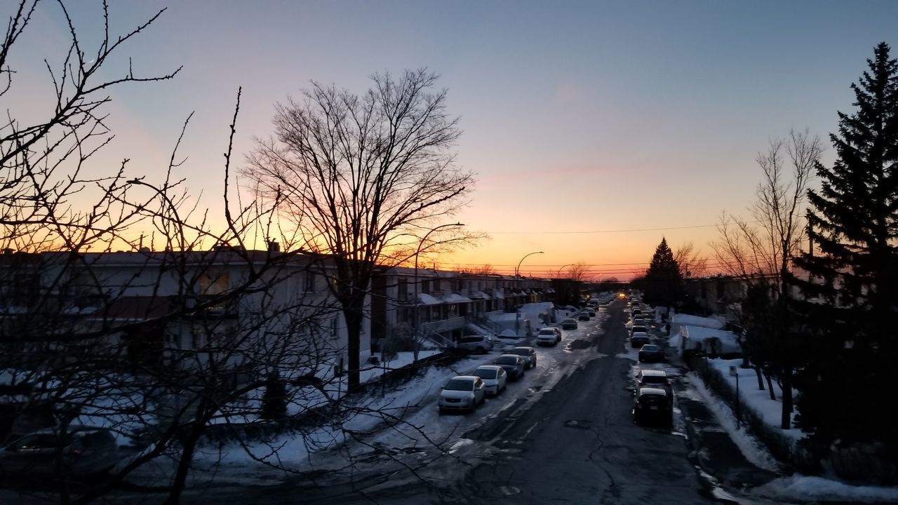 CARS ON ROAD AGAINST SKY DURING WINTER