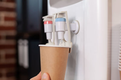 Close-up of hand holding coffee cup