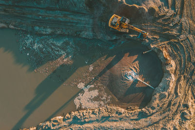 High angle view of earth mover digging land