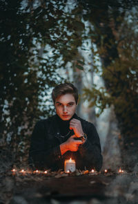 Portrait of young man in forest