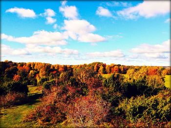 Scenic view of field against cloudy sky