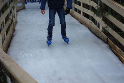 Low section of man standing on skateboard