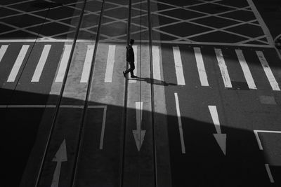 High angle view of man walking on road