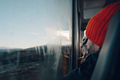 Reflection of man on train window