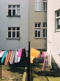 Fabrics drying on clotheslines outside building