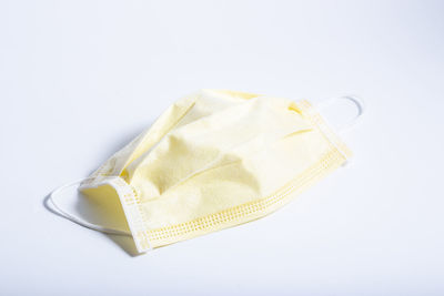 High angle view of yellow paper over white background