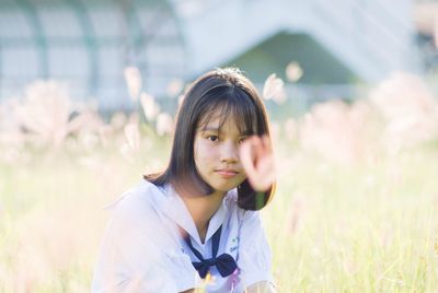 Portrait of young woman on field