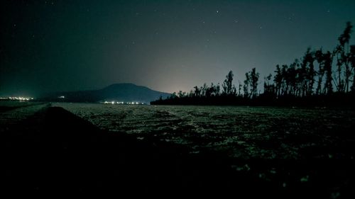 Scenic view of sea against clear sky at night