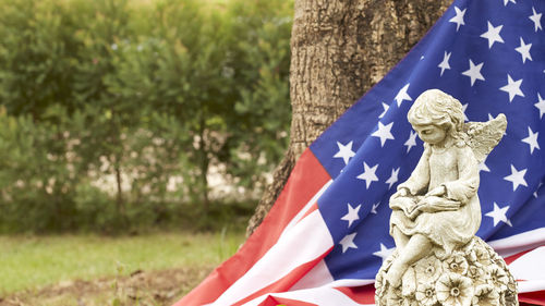 High angle view of statue by american flag at park