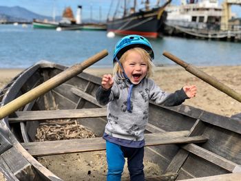 Portrait of boy standing in boat