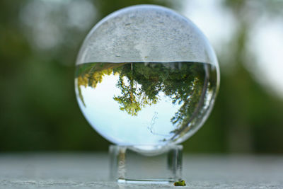 Close-up of glass sphere glass on table