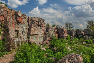 Rock formations against cloudy sky at pipestone national monument