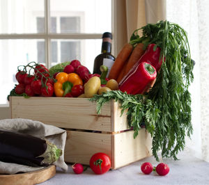 Midsection of woman picking vegetables on table