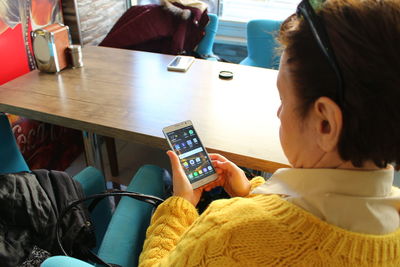 Midsection of woman using mobile phone