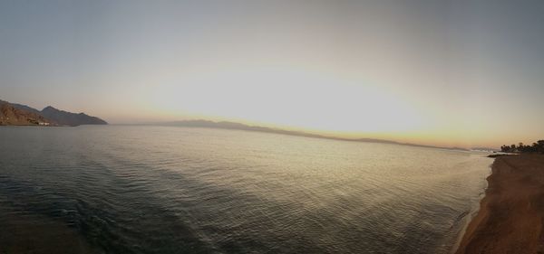 Scenic view of sea against clear sky during sunset