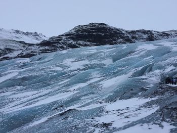 Low angle view of snowcapped mountain against sky