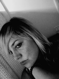 Close-up portrait of young woman at home