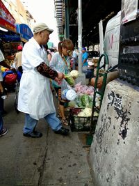 Full length of man having food at market stall