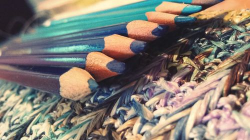 Close-up of colored pencils on patterned fabric