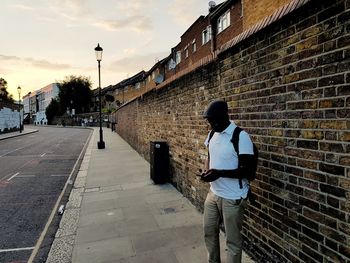 Full length of man standing on street in city