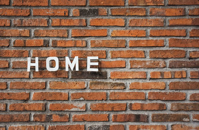 Close-up of text on brick wall