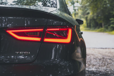 Close-up of wet car on road