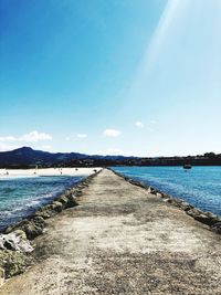 Scenic view of beach against blue sky