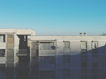 Sunlight falling on residential building against clear sky