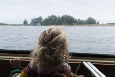 Rear view of woman in boat