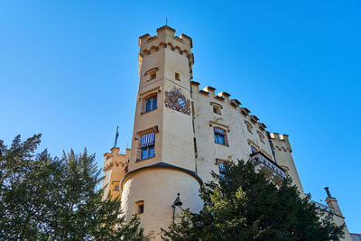 Low angle view of historic building against clear blue sky