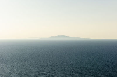 Scenic view of sea and island against clear sky greece 