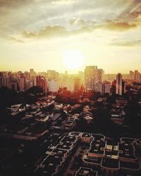 Aerial view of cityscape against sky during sunset