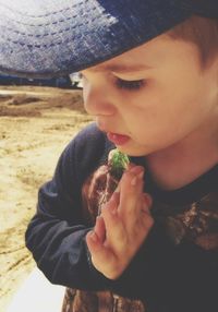 Close-up of cute boy eating outdoors