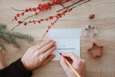 Cropped image of woman holding paper with text