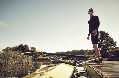 Young man near canoe