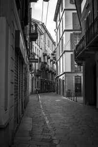 Empty alley amidst buildings in city