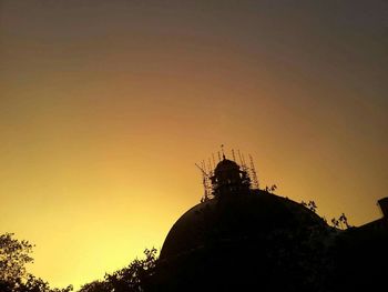 Low angle view of built structure at sunset