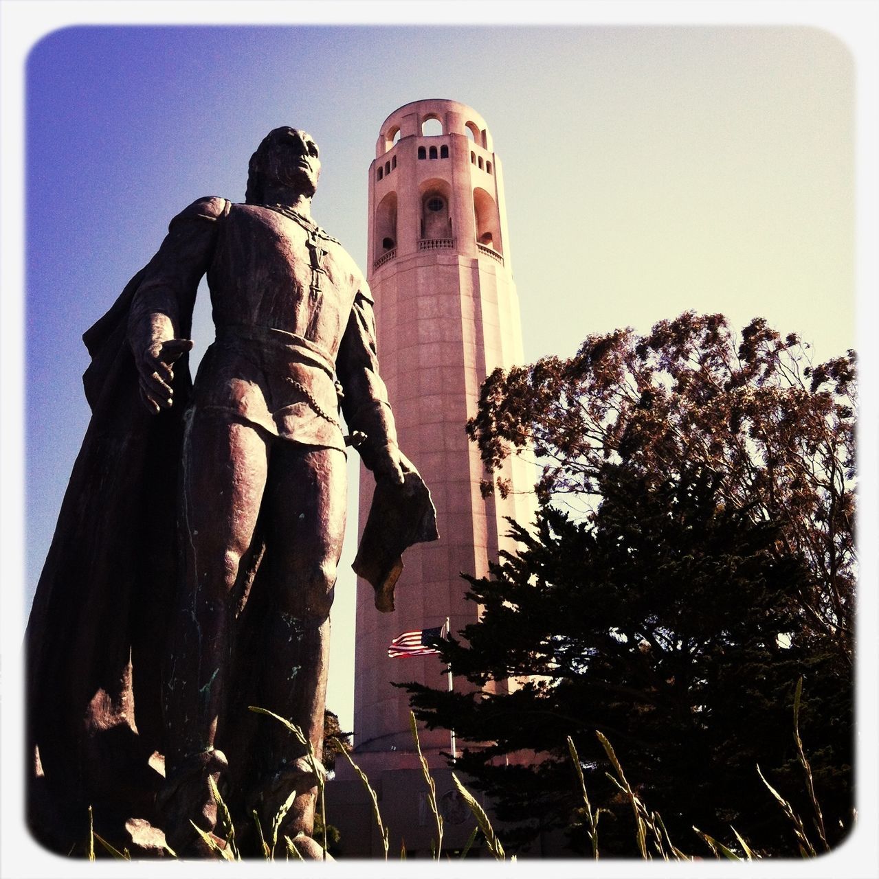 transfer print, auto post production filter, low angle view, building exterior, statue, sculpture, built structure, clear sky, architecture, sky, human representation, day, outdoors, religion, history, travel, tree, travel destinations