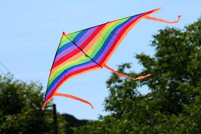 Low angle view of colorful kite against sky