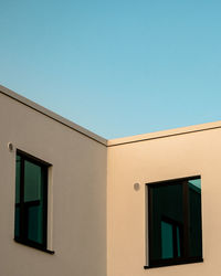 Low angle view of building against clear blue sky