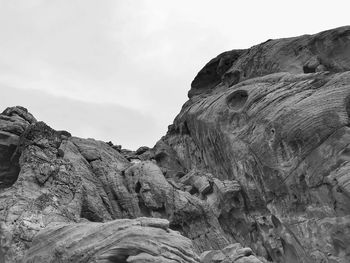 Low angle view of rock formation against sky