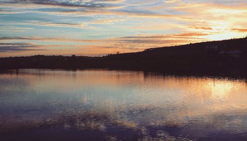 Scenic view of lake against sky during sunset