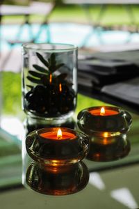 Close-up of lit tea light candles on table