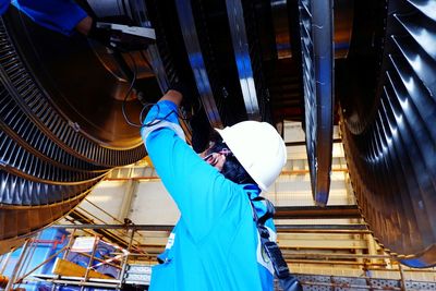 Low angle view of man standing in factory