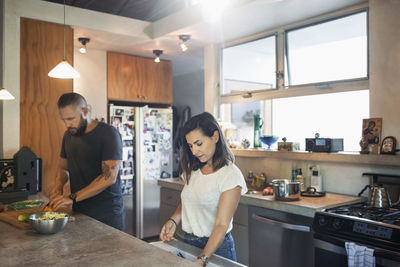 Couple preparing food together in kitchen