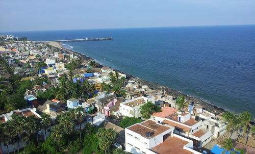 High angle view of townscape by sea against sky