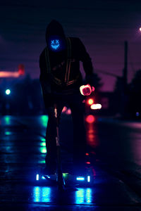  man standing on street at night 