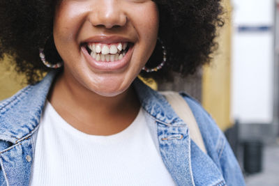 Cheerful young woman showing toothy smile